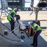 Passenger being deplaned on aislechair