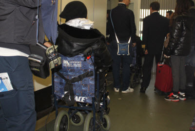 Access helping disabled passenger at Malpensa airport