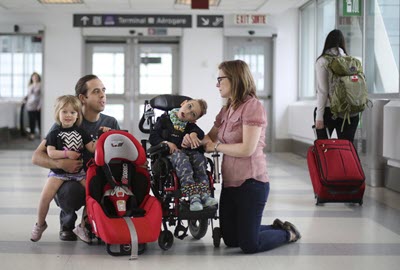 Child with cerebral palsy and his family at the airport